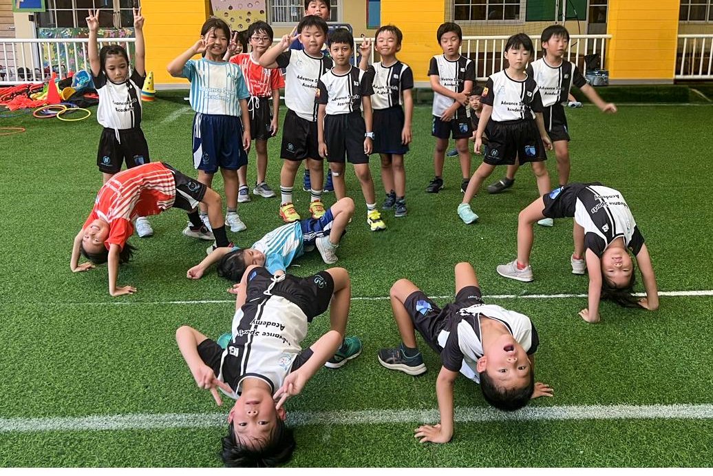 Enjoy Class children holding a bridge pose together