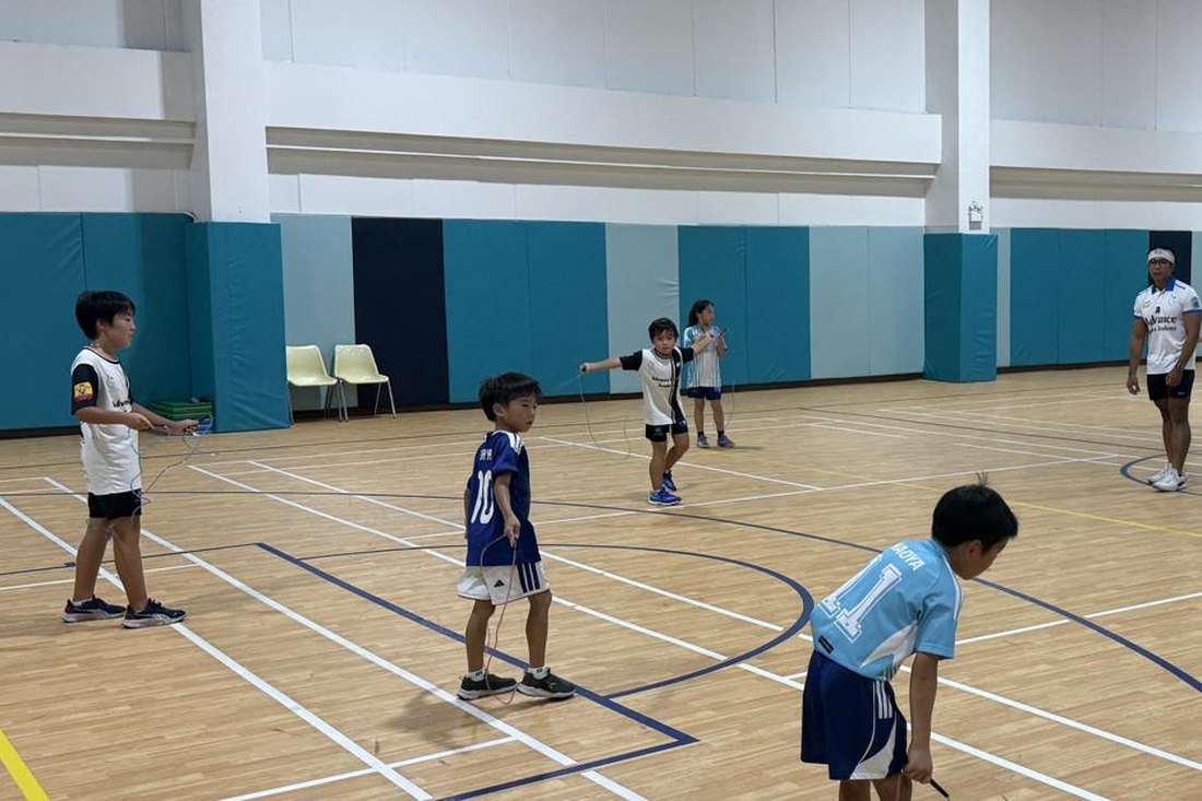 Children exercising with skipping ropes