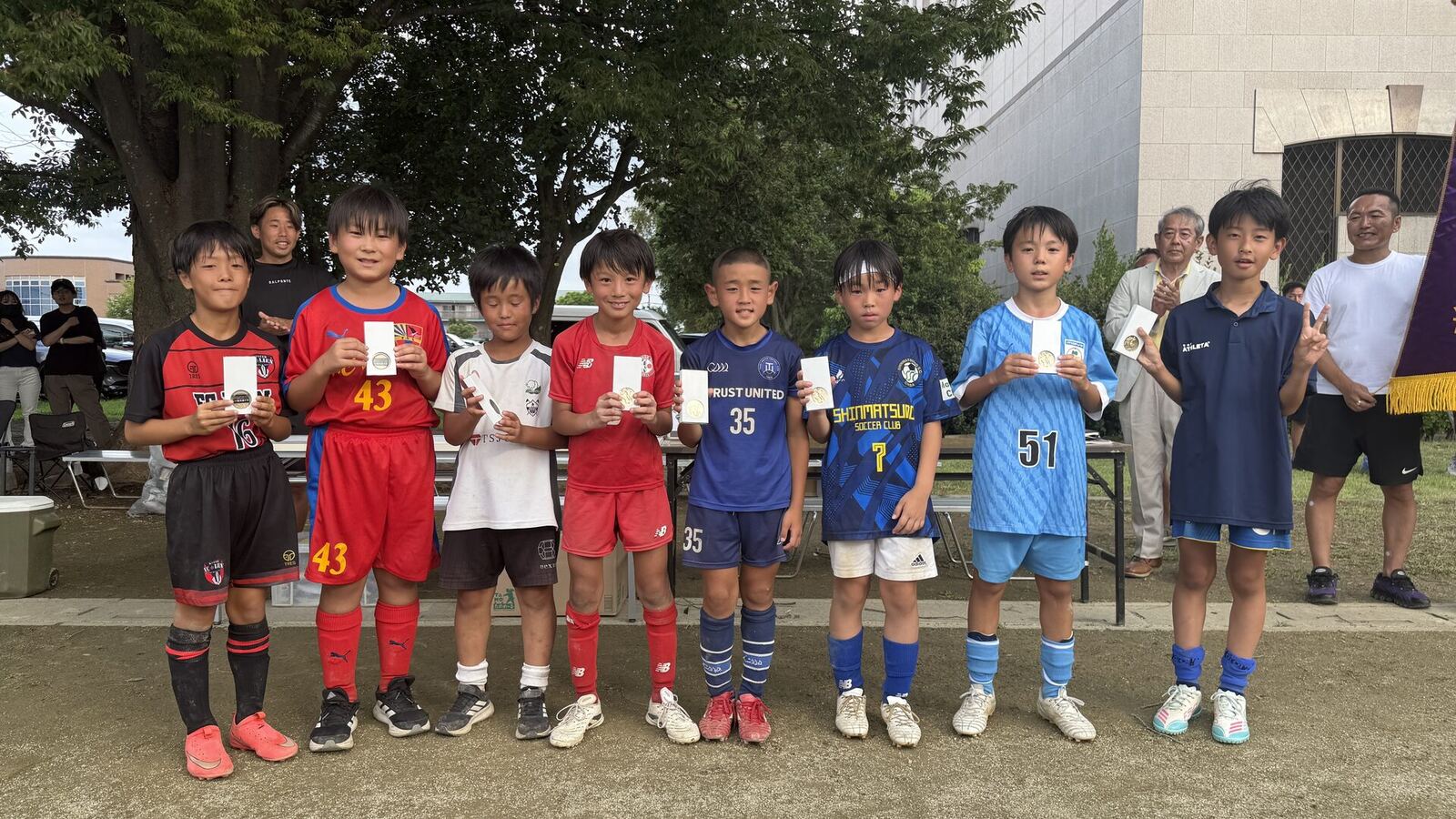 各チームから選ばれた優秀選手がメダルを手に並ぶ表彰式の様子
