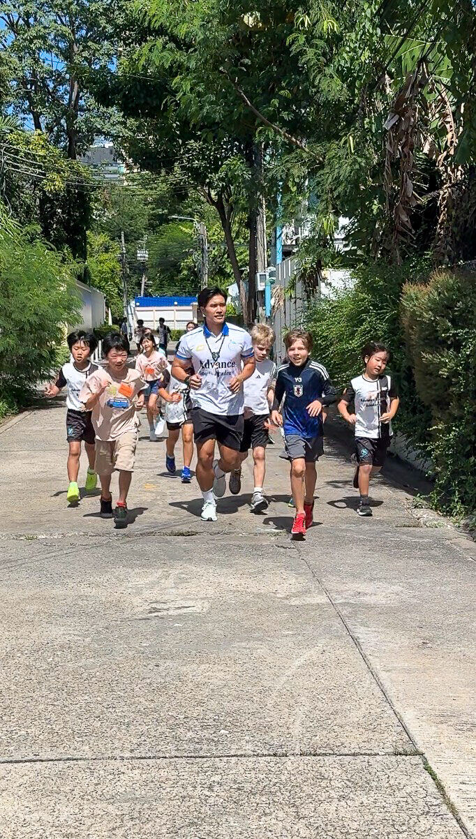 Children running together with a coach
