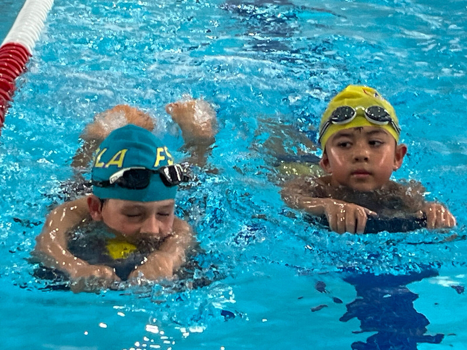 Children receiving swim coaching in the pool